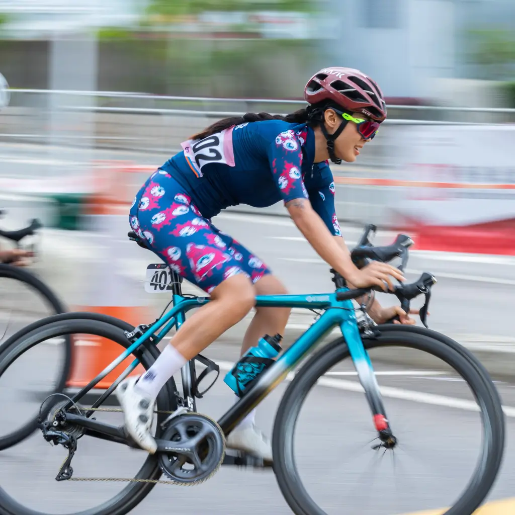 A woman cycling competitively after having obtained a medical certificate from Fit Certify.