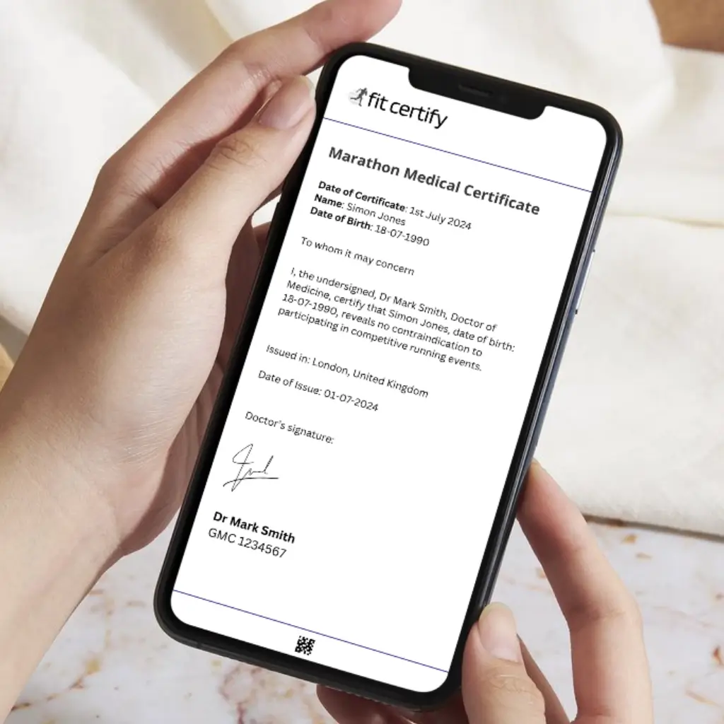 A person holding a mobile phone that is displaying a marathon medical certificate, issued by a UK-registered doctor at Fit Certify.